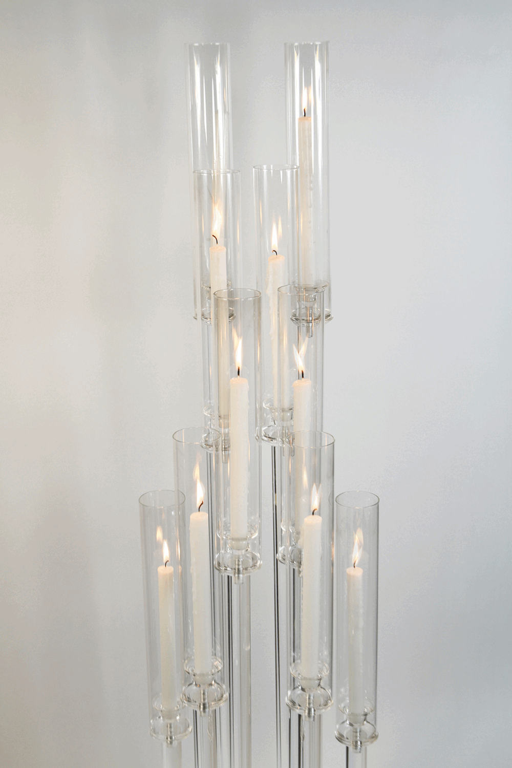 A grand prism acrylic candelabra stand, sparkling with many branches for candles.